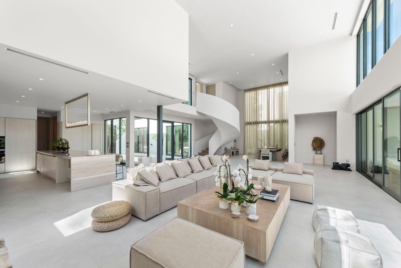 Double-height living room with spiral stair