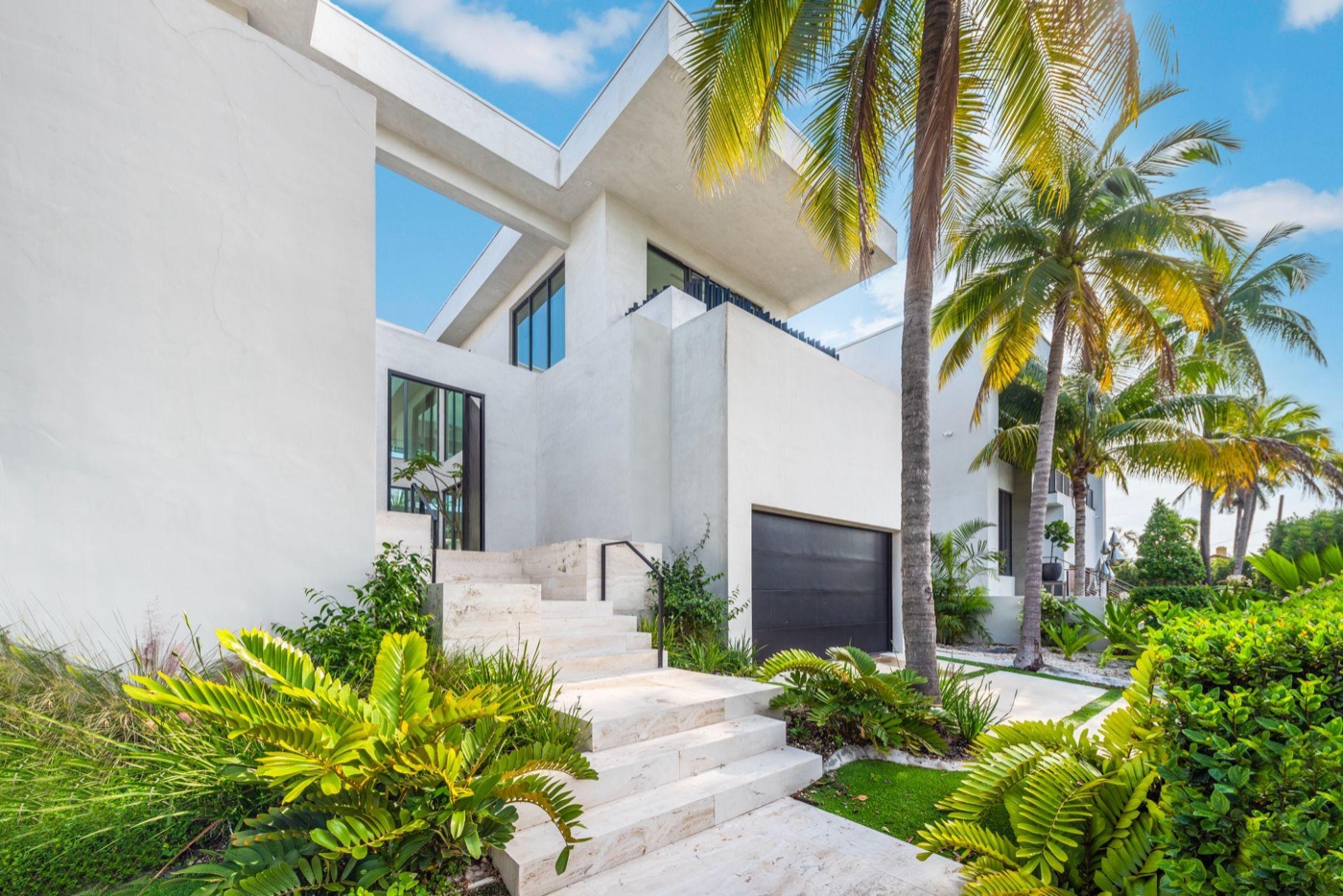 Main entry with travertine steps and palms